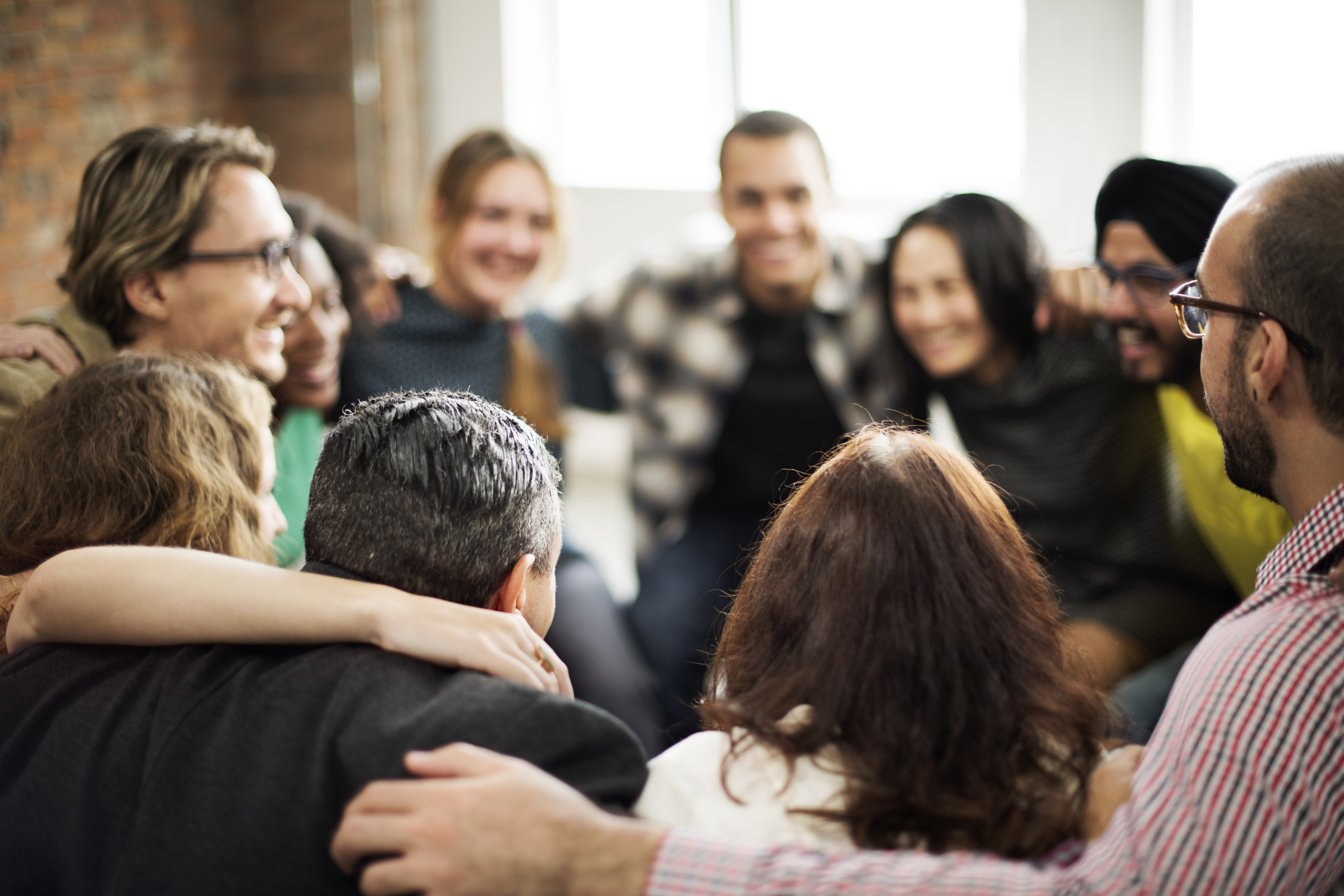 Diverse group of people sitting together in a circle